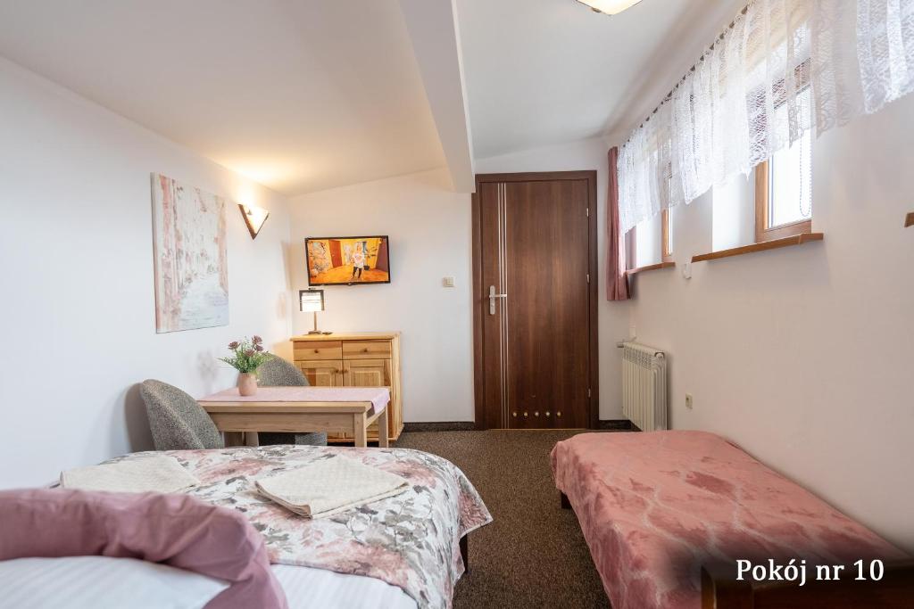 Postel nebo postele na pokoji v ubytování Willa Puchatek