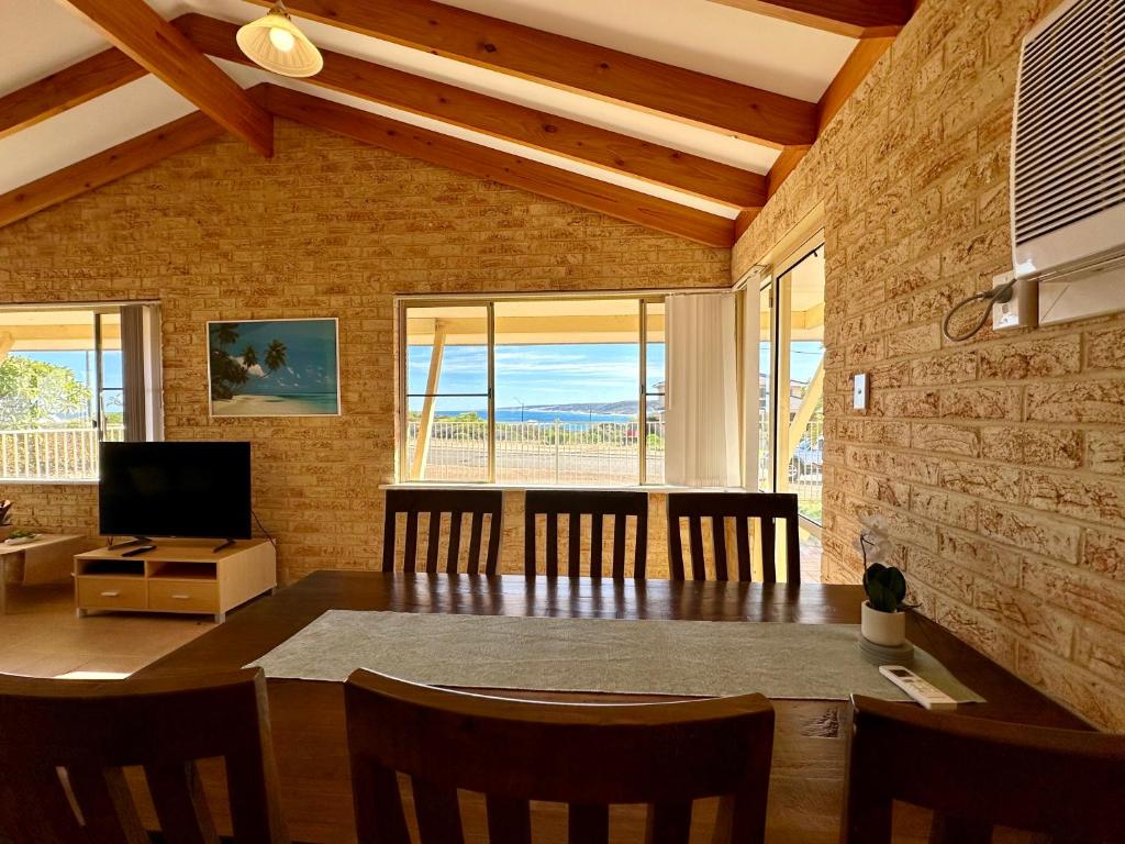 a dining room with a table and a view of the ocean at Cliffs Unit 1 - KalbarriWA in Kalbarri