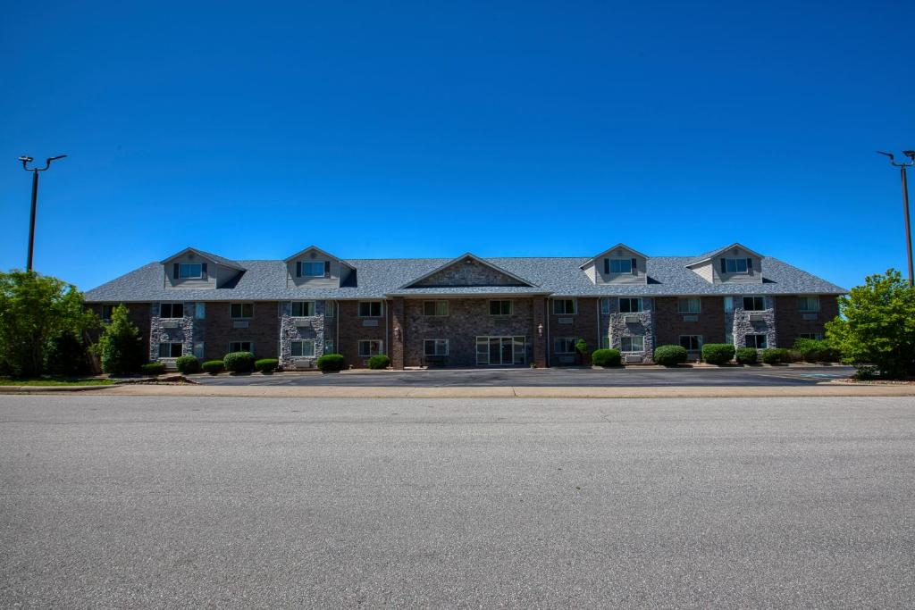 a large building on the side of a road at All Towne Suites in Saint Robert