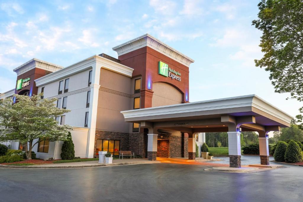 a rendering of a hotel with a parking lot at Holiday Inn Express Burlington, an IHG Hotel in Burlington