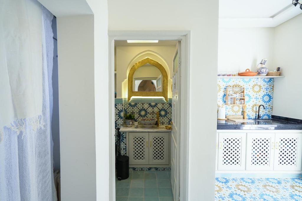 a bathroom with a sink and a mirror at Dar Badr in Tangier