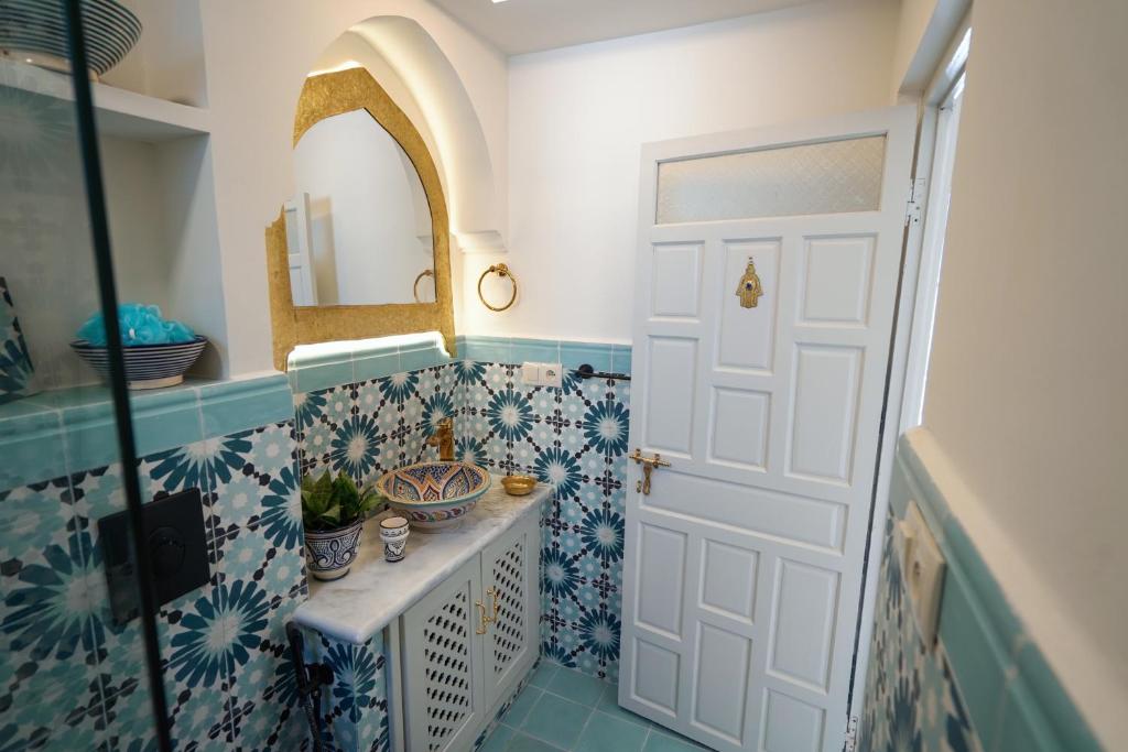 a bathroom with a sink and a mirror at Dar Badr in Tangier