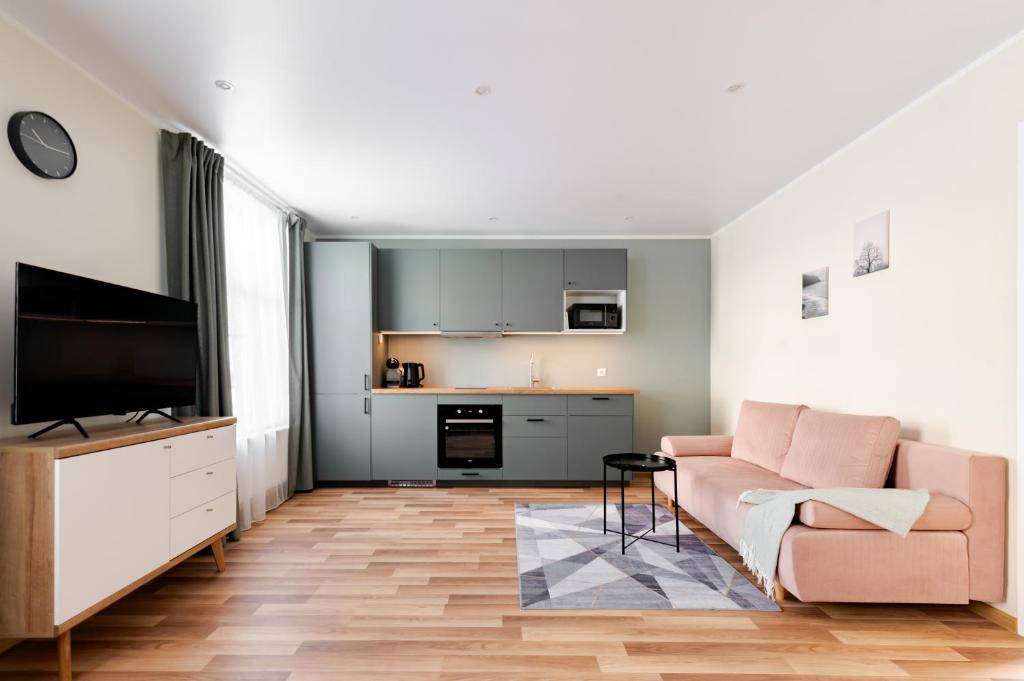 a living room with a couch and a television at Liidia Apartments in Haapsalu