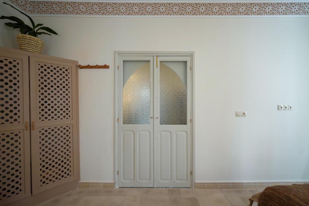 a white door in a room with a cabinet at Dar Badr in Tangier