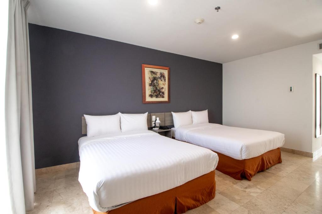 Postel nebo postele na pokoji v ubytování Memora Hotel & Villas Chapala