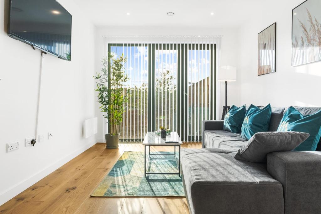 a living room with a couch and a table at Pluxa Emerald Luxury - Walk to Attractions, Transport Nearby in Birmingham