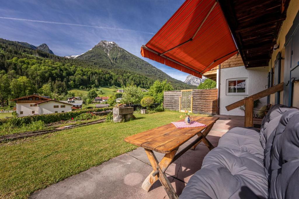 a patio with a table and a view of a mountain at Haus Drischlag Fewo Drischlag 1 in Ramsau