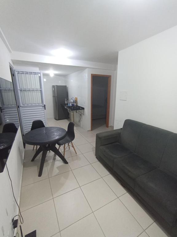 a living room with a couch and a table at Apartamento para São João in Campina Grande