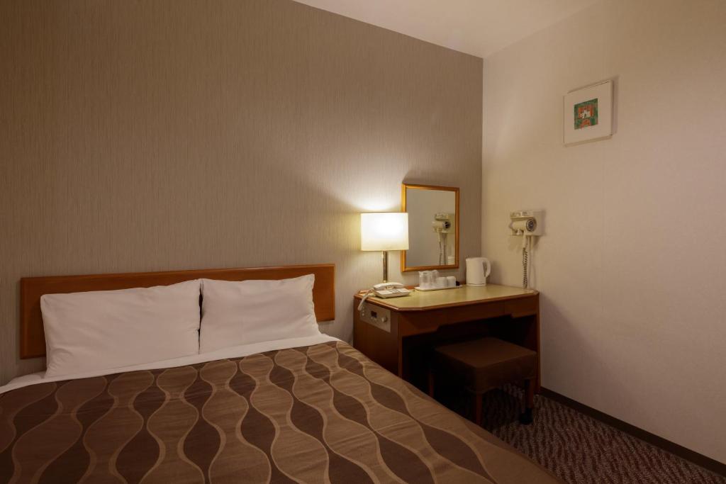 Postel nebo postele na pokoji v ubytování Center Hotel Narita1