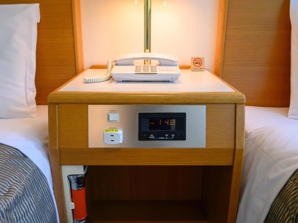Postel nebo postele na pokoji v ubytování Rest Inn Taga