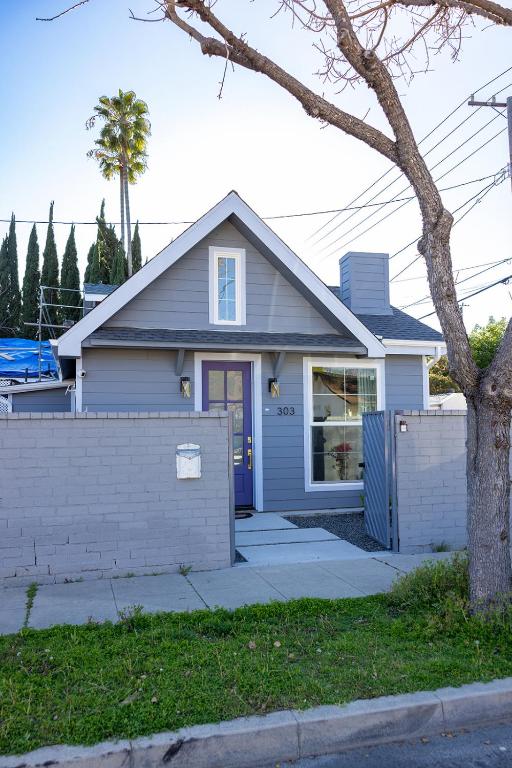 a blue house with a fence in front of it at Hollywood Family Nest in Burbank, Steps to Studios! in Burbank