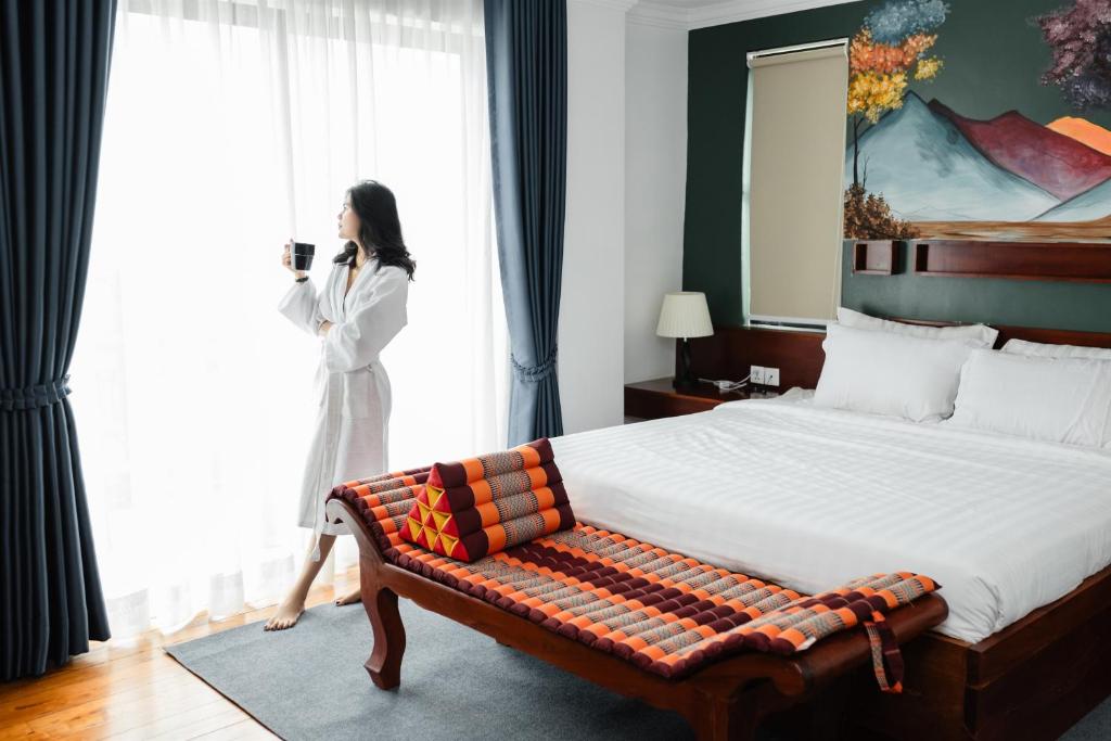 Postel nebo postele na pokoji v ubytování Le Vert Angkor Hotel