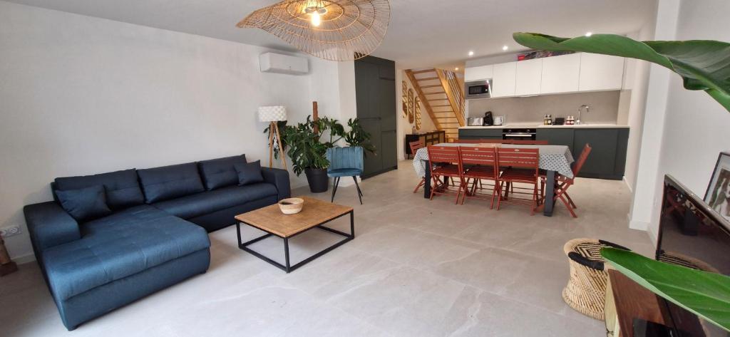 un salon avec un canapé bleu et une table dans l'établissement Villa Provençale, à Sète