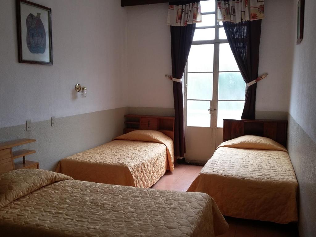 En eller flere senge i et værelse på Hotel Centenario