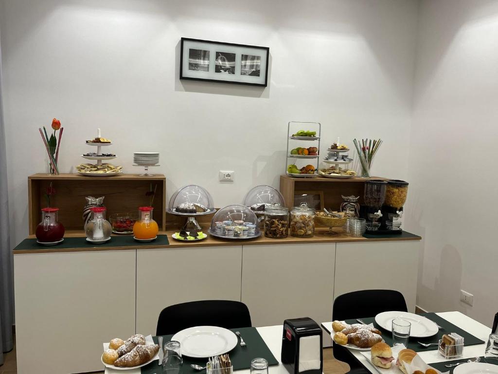 a room with a table with plates of food at Room & Breakfast Aloe in San Vito lo Capo