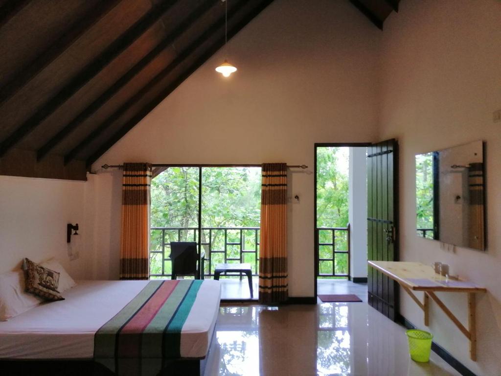 アヌラーダプラにあるMalwathu Oya Forest Gardenのベッドルーム1室(ベッド1台、大きな窓付)