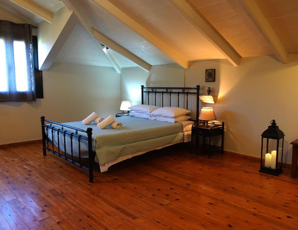 a bedroom with a bed and two lamps on a wooden floor at LITHARI PENTHOUSE in Alikanas