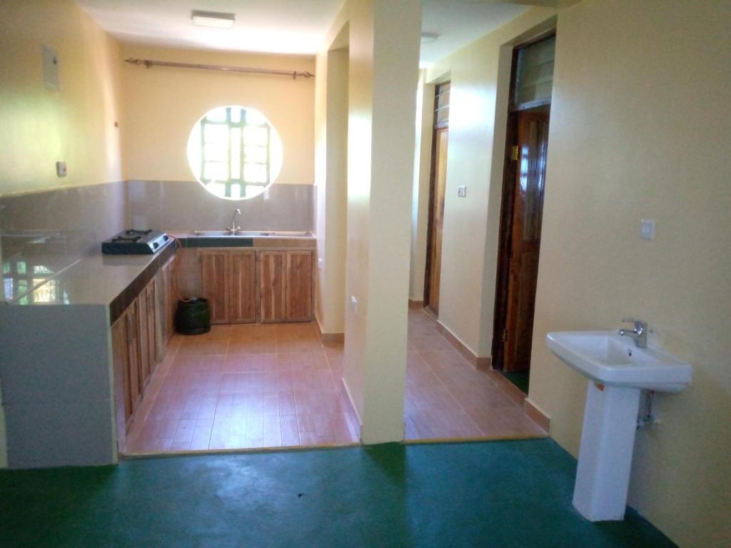 a bathroom with a sink and a toilet in it at Rhino hillside in Sekenani