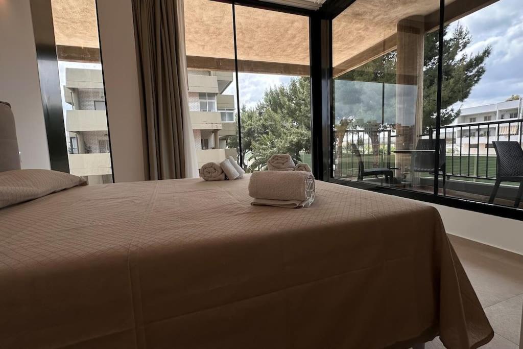 a bedroom with a large bed with a large window at CconfortHotels Puglia Promenade Apartment 4 in Bari