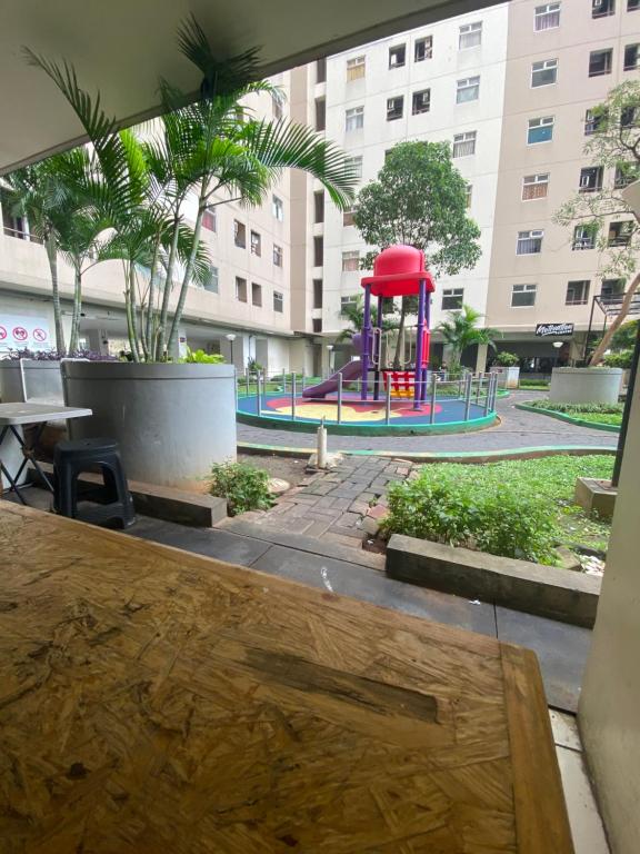 a playground in a building with a table and a bench at Kalibata city apartemen tower akasia in Jakarta