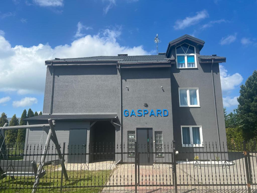 a building with a sign on the side of it at Gaspard in Sarbinowo