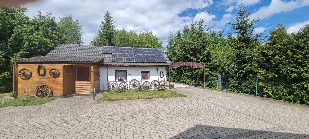 a small house with solar panels on top of it at Villa Fantastica Apartments in Mysłakowice
