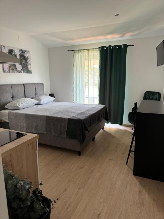 a bedroom with a large bed and a window at Apartments Maris in Umag