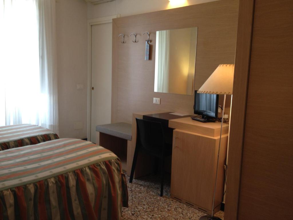 Postel nebo postele na pokoji v ubytování Albergo Giugni
