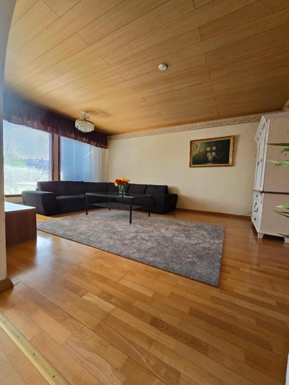 a living room with a couch and a table at Anttoninvahe 7 130m2 with garden and sauna etc in Rauma