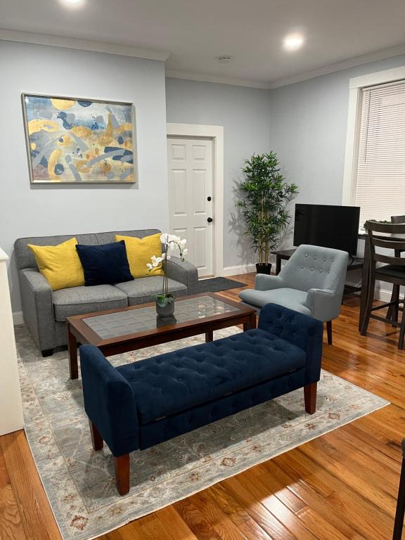a living room with a couch and a table at Spacious Apartment in Boston in Boston