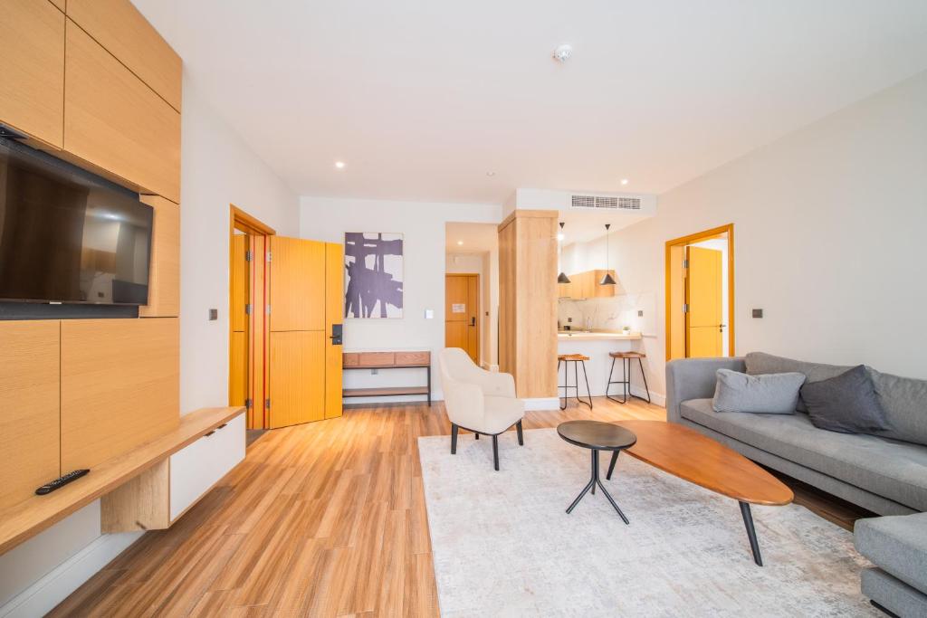 a living room with a couch and a table at Loft Hotel Apartment in Addis Ababa