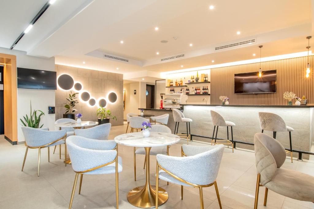 a restaurant with tables and chairs and a bar at Loft Hotel Apartment in Addis Ababa