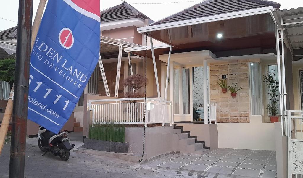 ein Haus mit einer Flagge davor in der Unterkunft VILLA YANTI PERMATA GARDEN in Karangploso