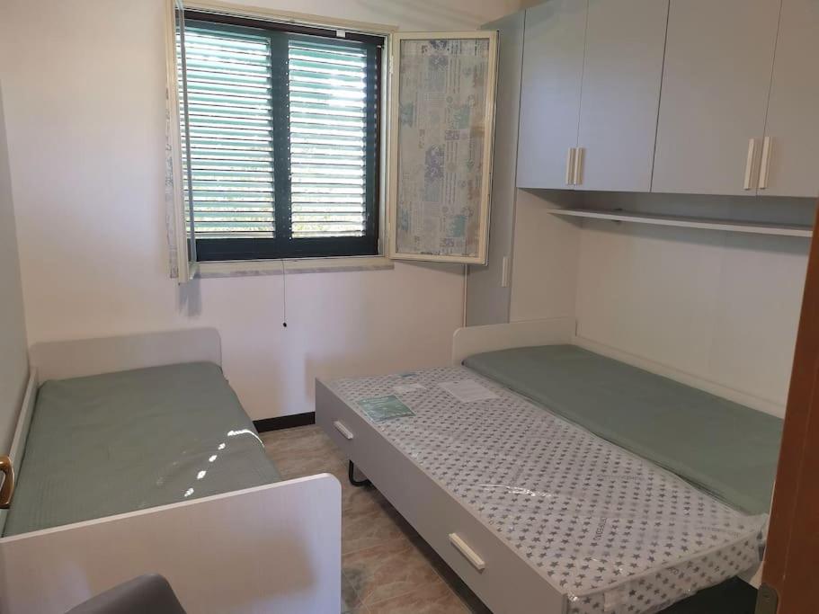 Postel nebo postele na pokoji v ubytování Serenity House 80mq vista mare