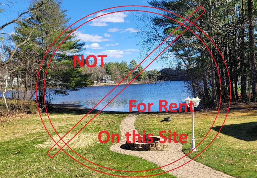 a sign that says not for rent on a lake at Piscataquog Reservoir House in Goffstown