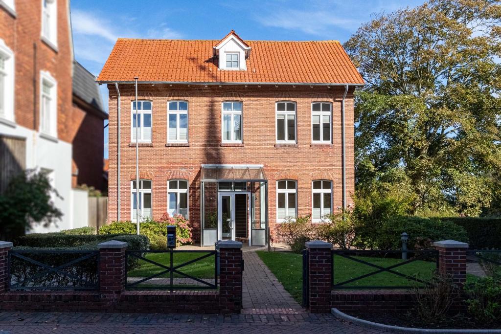 an old brick house with an orange roof at Gaestehaus-St-Josef-5 in Borkum