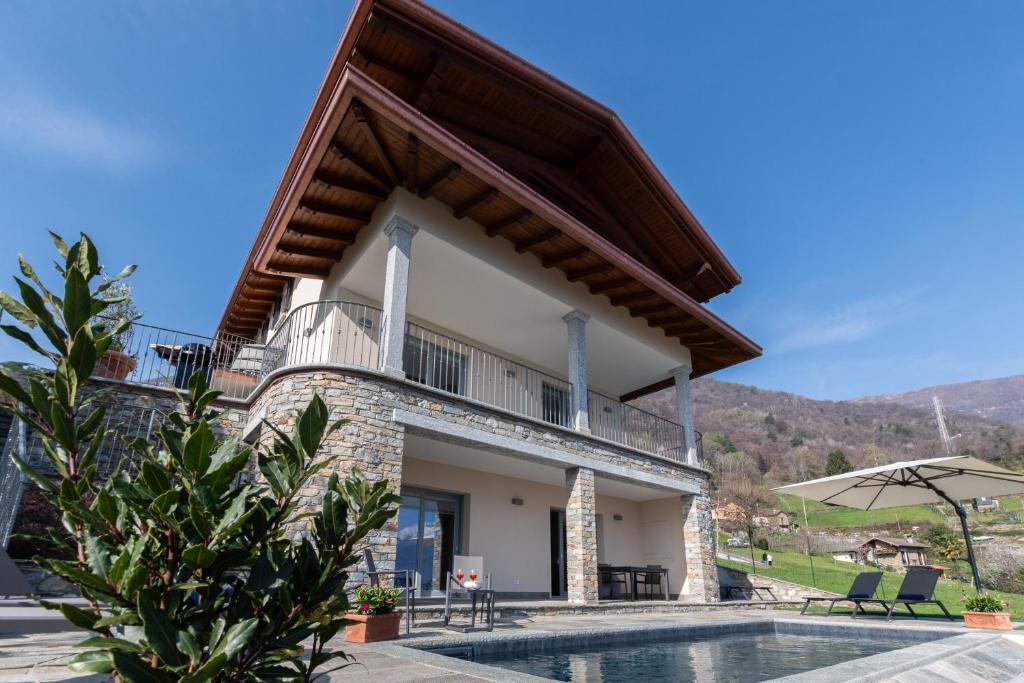 a villa with a swimming pool and a house at VILLA SANT'ANNA by Curtiaffitti in Pianello Del Lario