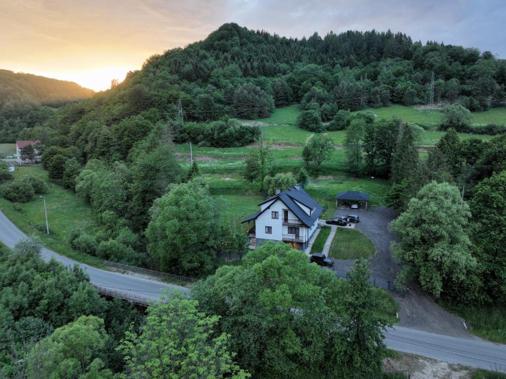 an aerial view of a house on a hill with a road at Bieszczadzki Brzeg in Wołkowyja