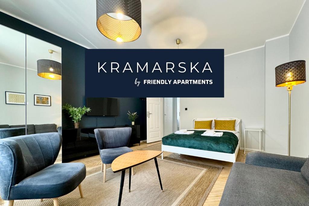 ポズナンにあるKRAMARSKA Residence - Old Market Square by Friendly Apartmentsのベッドと椅子、看板が備わる客室です。