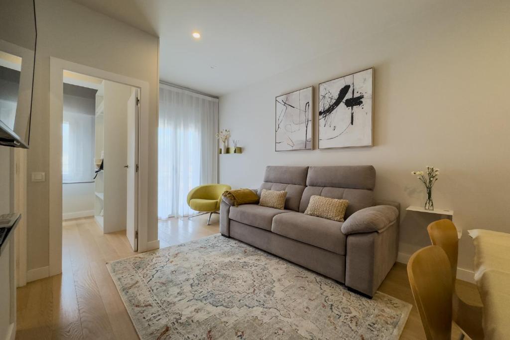 a living room with a couch and a rug at Barcelona Amelie Apartment in Hospitalet de Llobregat