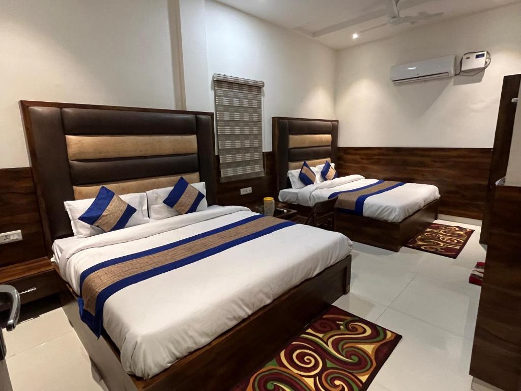 a bedroom with two beds in a room at Hotel SB Residency in Amritsar