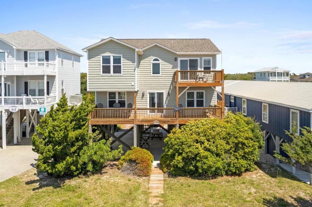 a large house with a deck in front of houses at Chipps Ahoy in Oak Island