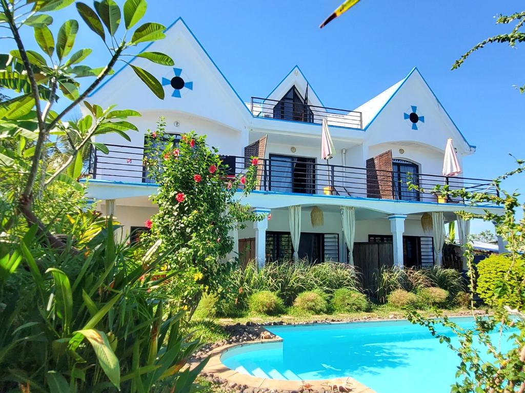 una casa con piscina frente a ella en Villa Malandy Appart Hôtel Duplex 1, en Ambatoloaka