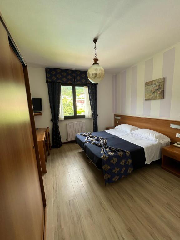 Postel nebo postele na pokoji v ubytování Hotel Merloni