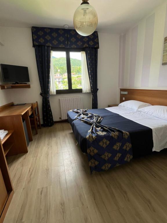 Postel nebo postele na pokoji v ubytování Hotel Merloni