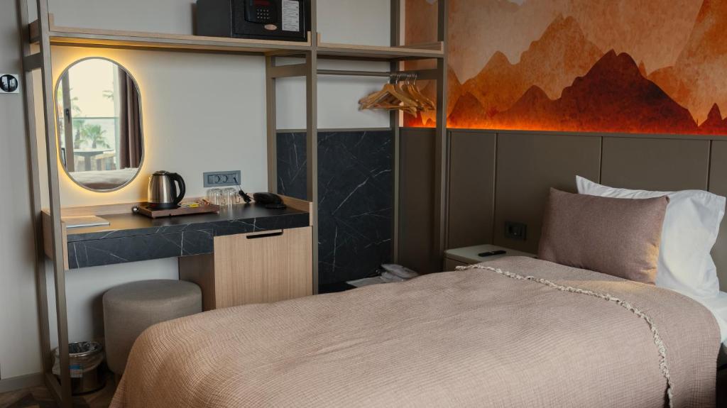 A bed or beds in a room at Kleopatra Dreams Beach Hotel