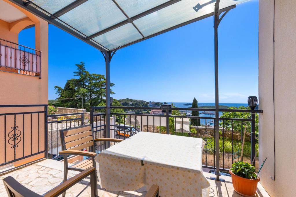 a patio with a table and chairs on a balcony at Studio with terrace & sea view in Vrsar