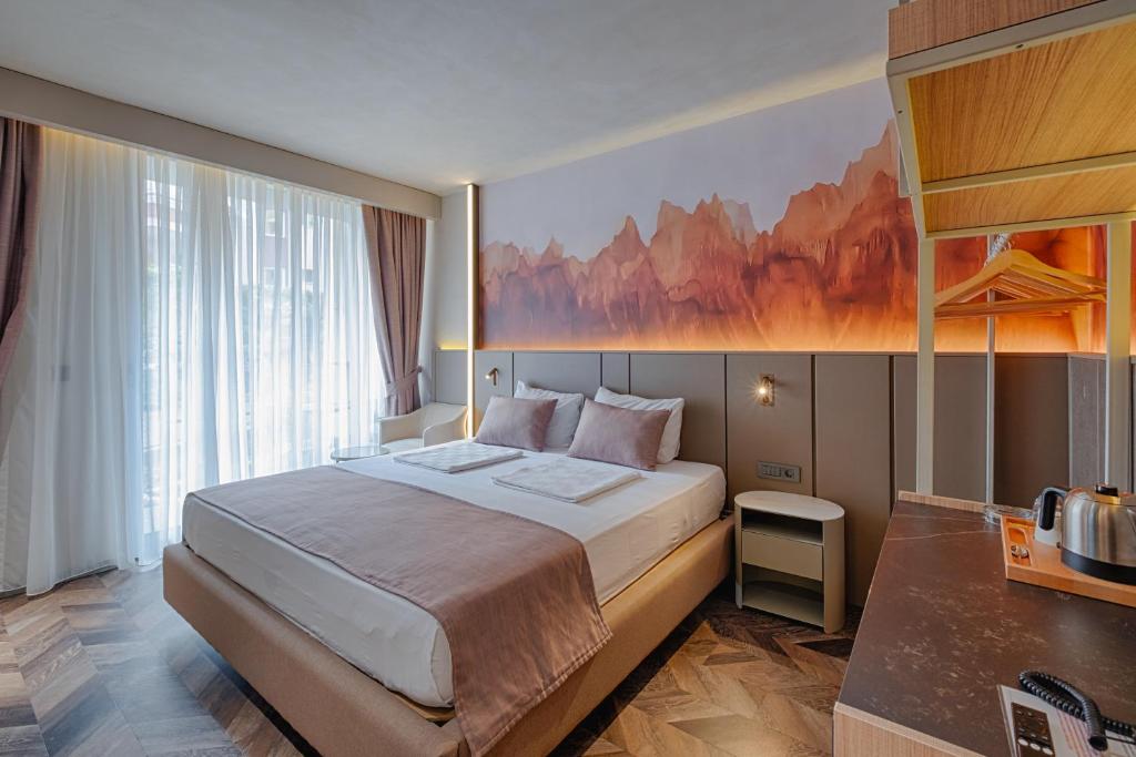 A bed or beds in a room at Kleopatra Dreams Beach Hotel