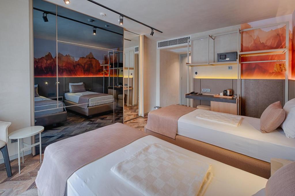 A bed or beds in a room at Kleopatra Dreams Beach Hotel