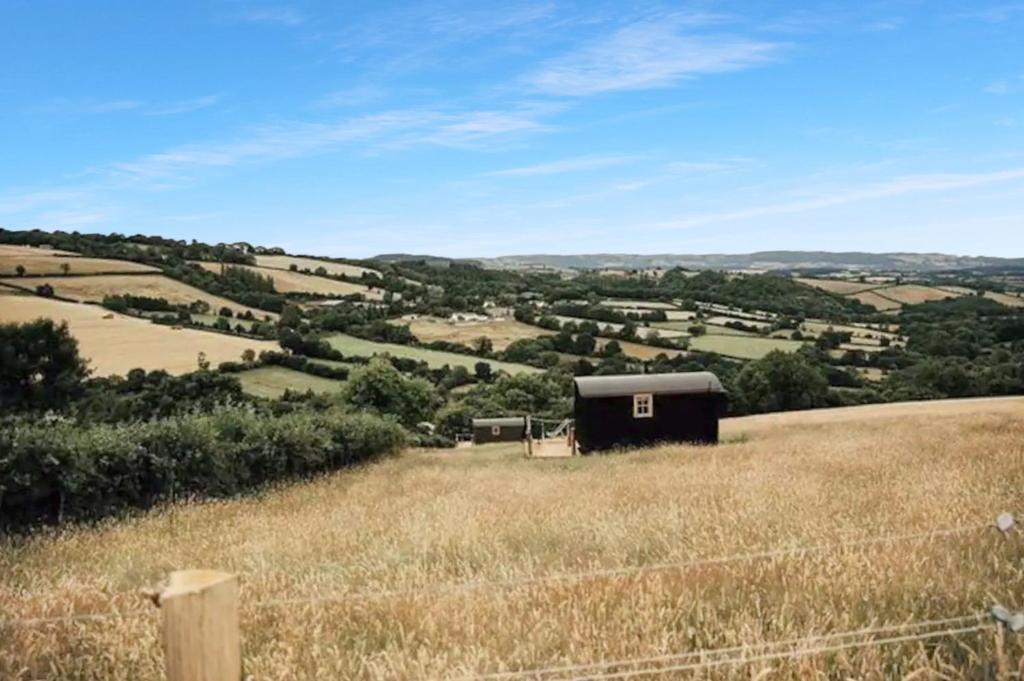 a barn in the middle of a field at Ash Hut Wiveliscombe in Wiveliscombe